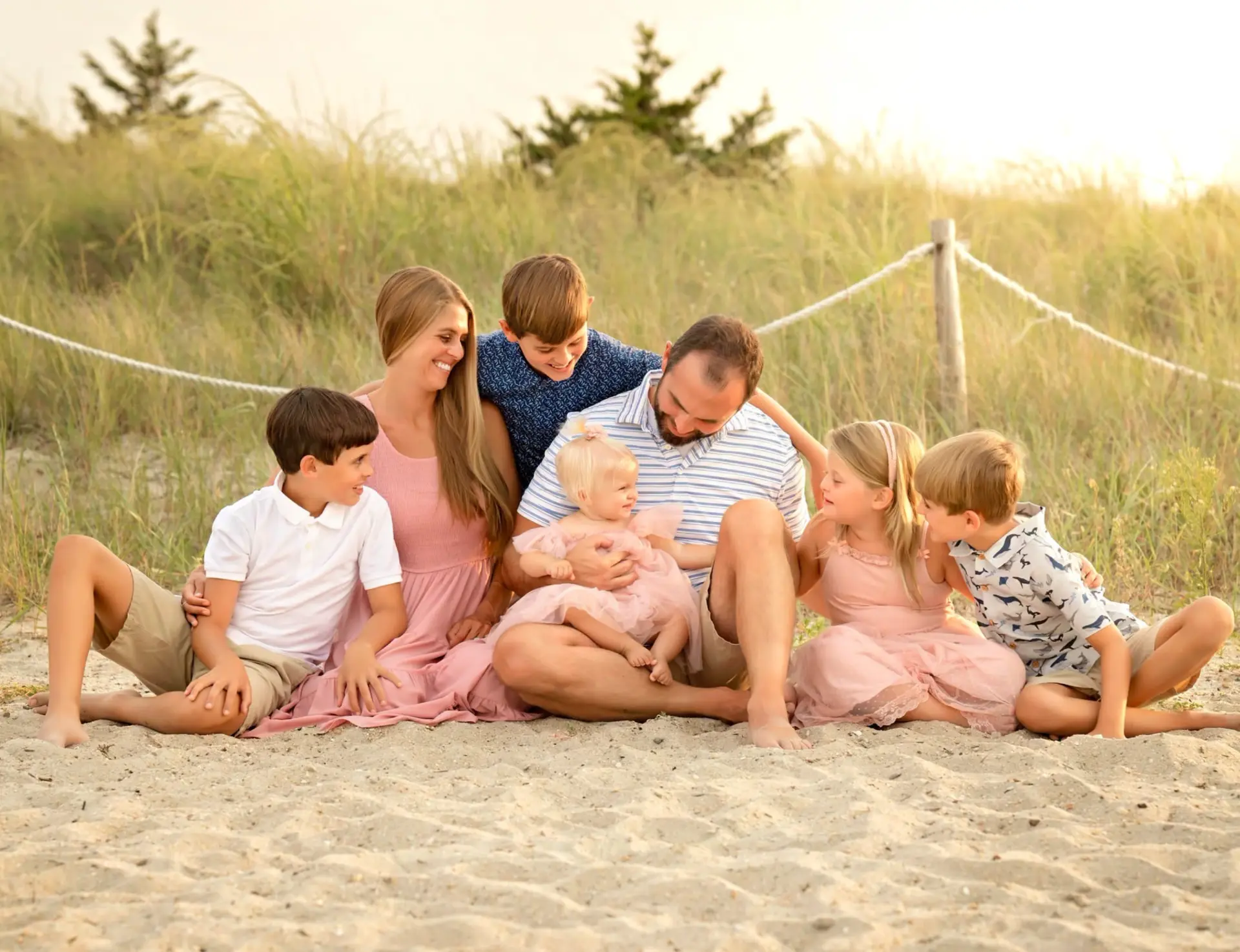 Family seated together on the beach