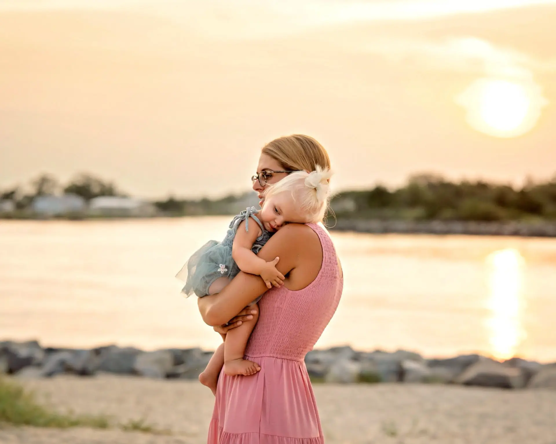 Mother holding her child by the water